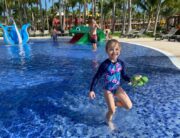Child having fun in splash pad at resort
