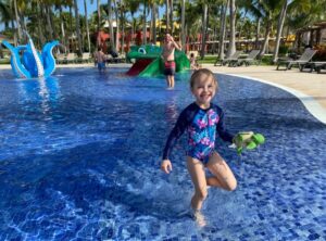 Child having fun in splash pad at resort