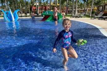 Child having fun in splash pad at resort