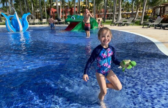 Child having fun in splash pad at resort