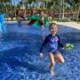 Child having fun in splash pad at resort